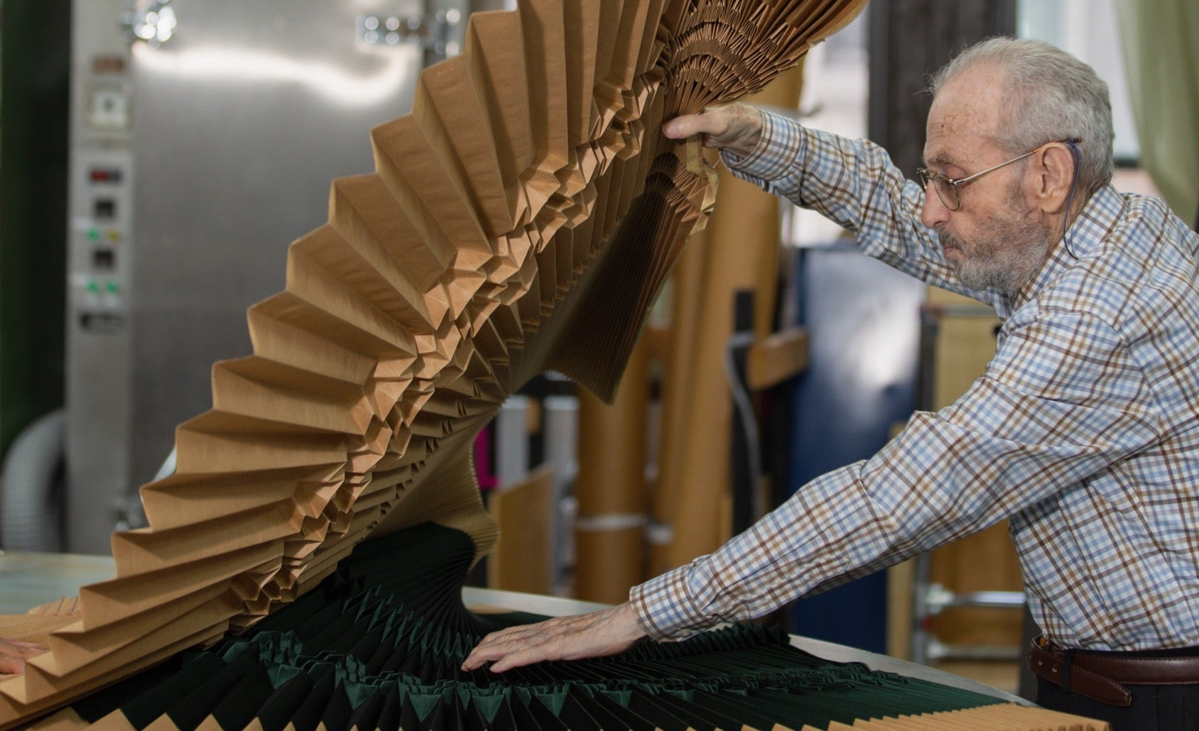 Photo of Leon Kalajian opening a sunburst fantasy mold with green silk