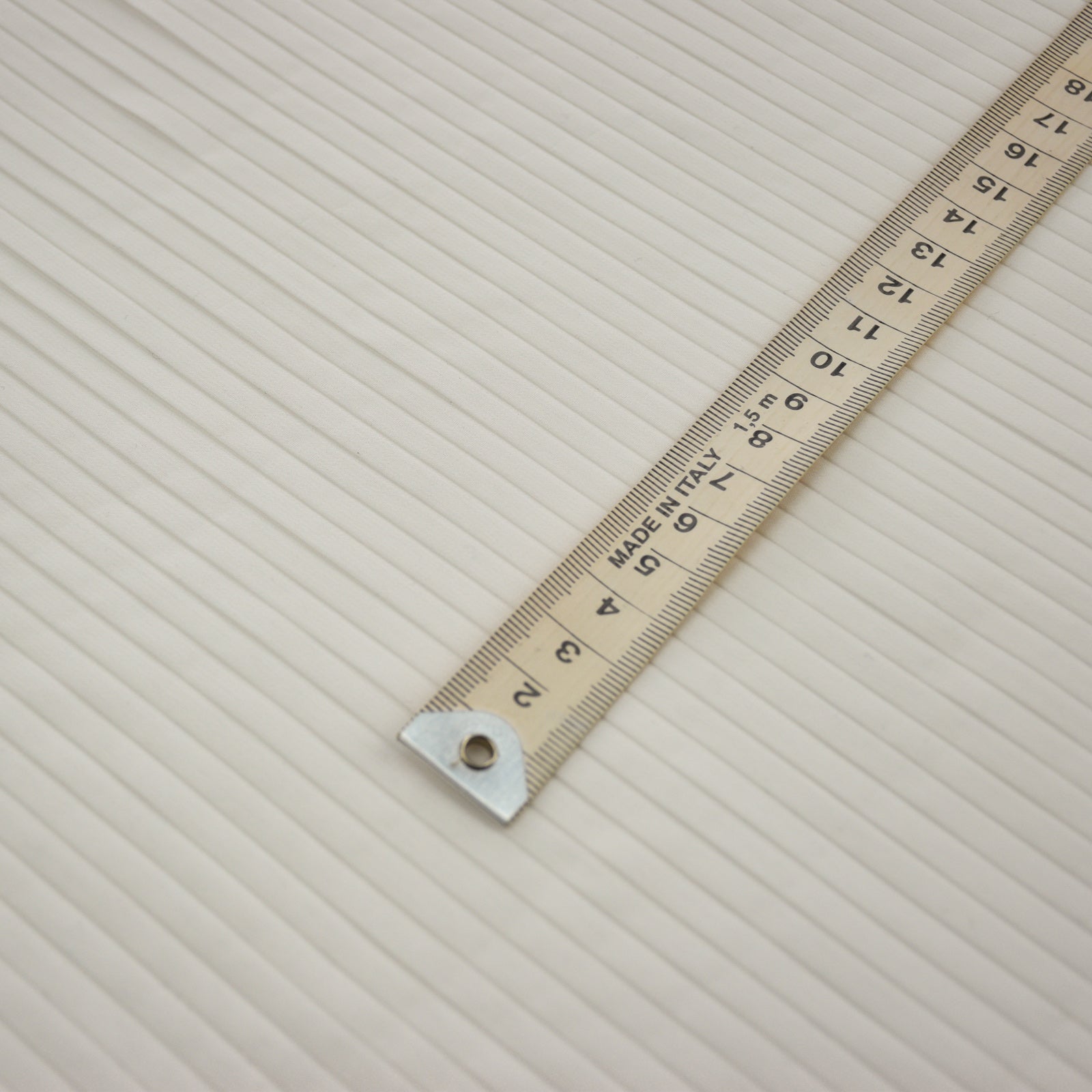 quarter inch side pleating with a metric ruler on top for scale