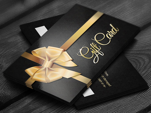 A black gift card with a gold ribbon design and the words 'GIFT CARD' printed in gold for Toms Sons International Pleating