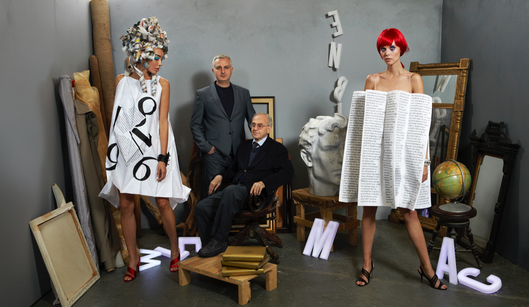 Father and son George and Leon Kalajian posing with 2 models wearing pleated looks 