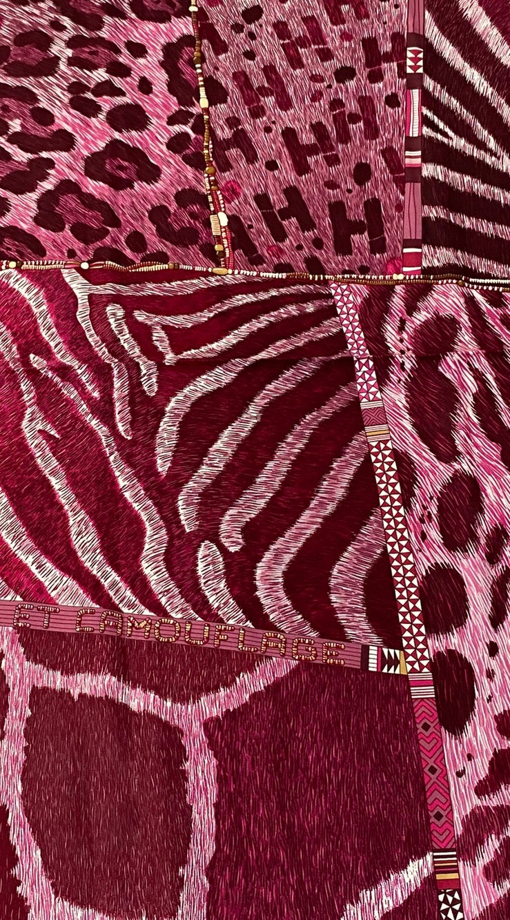 Close-up of a Hermes Scarf 90 with animal print pattern in different shades of pink 