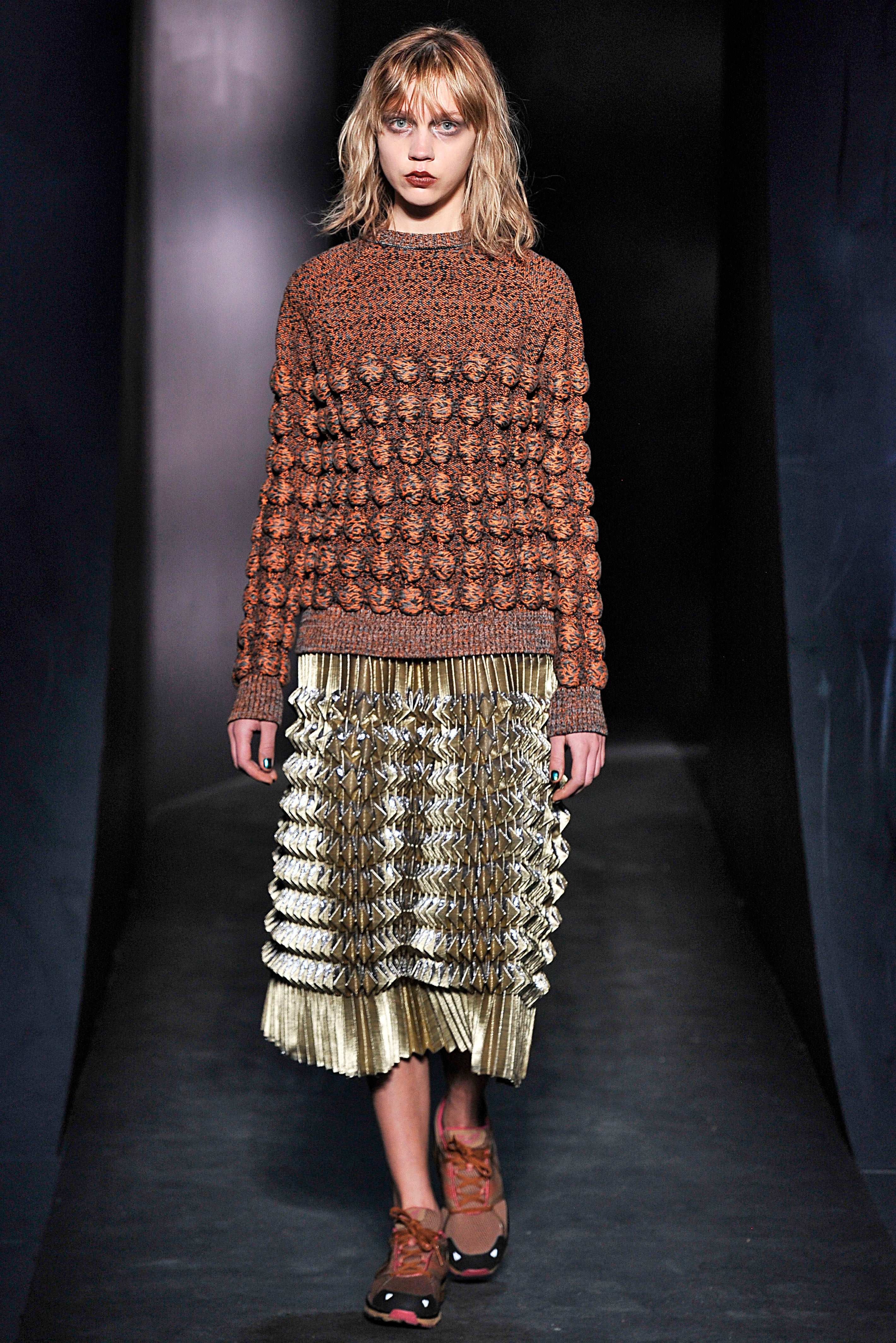 chunky sweater with gold lame fantasy pleated mid length skirt 